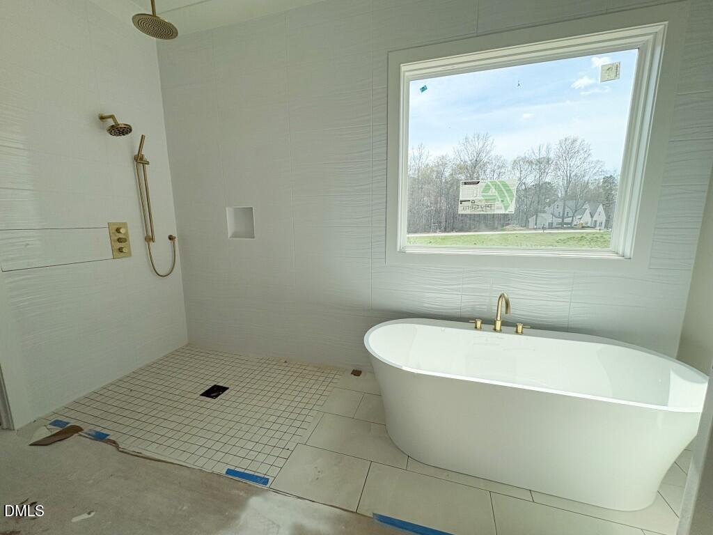 5864 Carriage Gate Drive Raleigh, NC 27603 - Photo 12 of 37 a white bath tub sitting next to a shower