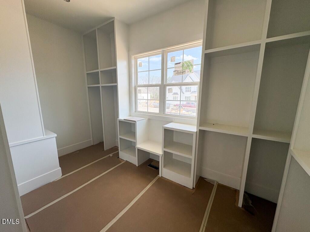 5864 Carriage Gate Drive Raleigh, NC 27603 - Photo 13 of 37 a room with walk in closet and a window