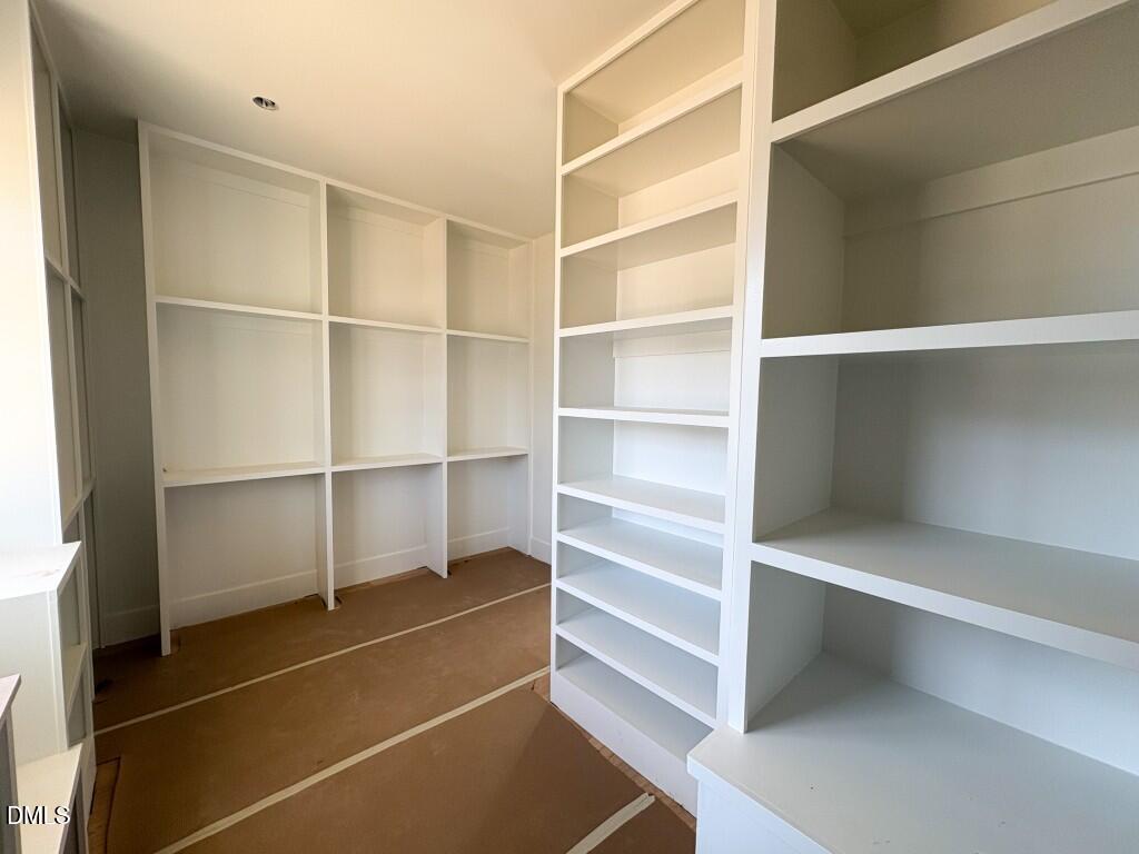 5864 Carriage Gate Drive Raleigh, NC 27603 - Photo 14 of 37 a view of walk in closet with empty racks