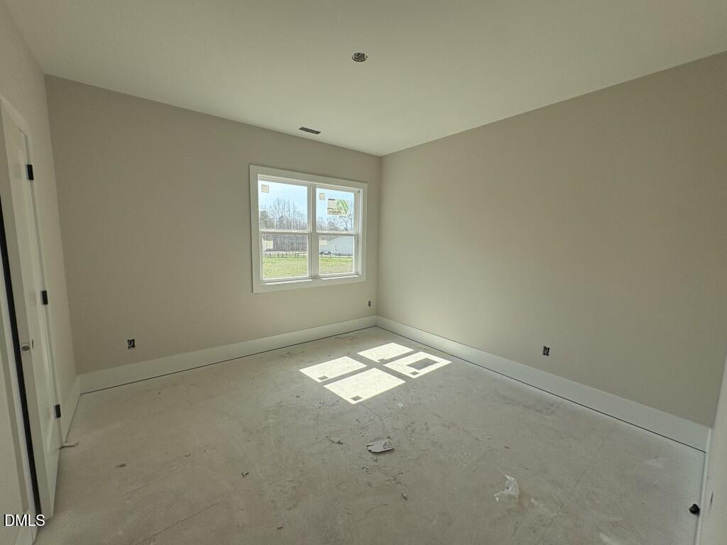 5864 Carriage Gate Drive Raleigh, NC 27603 - Photo 17 of 37 an empty room with windows