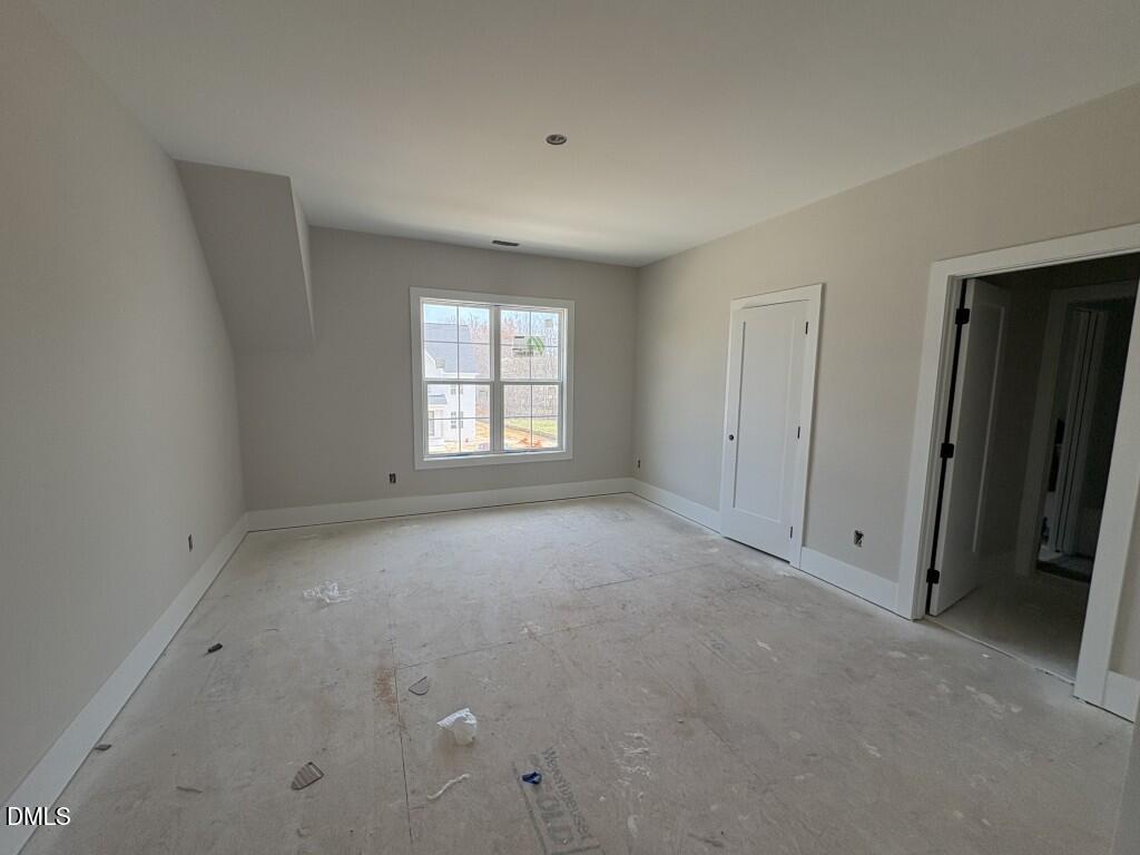 5864 Carriage Gate Drive Raleigh, NC 27603 - Photo 20 of 37 a view of an empty room with a window