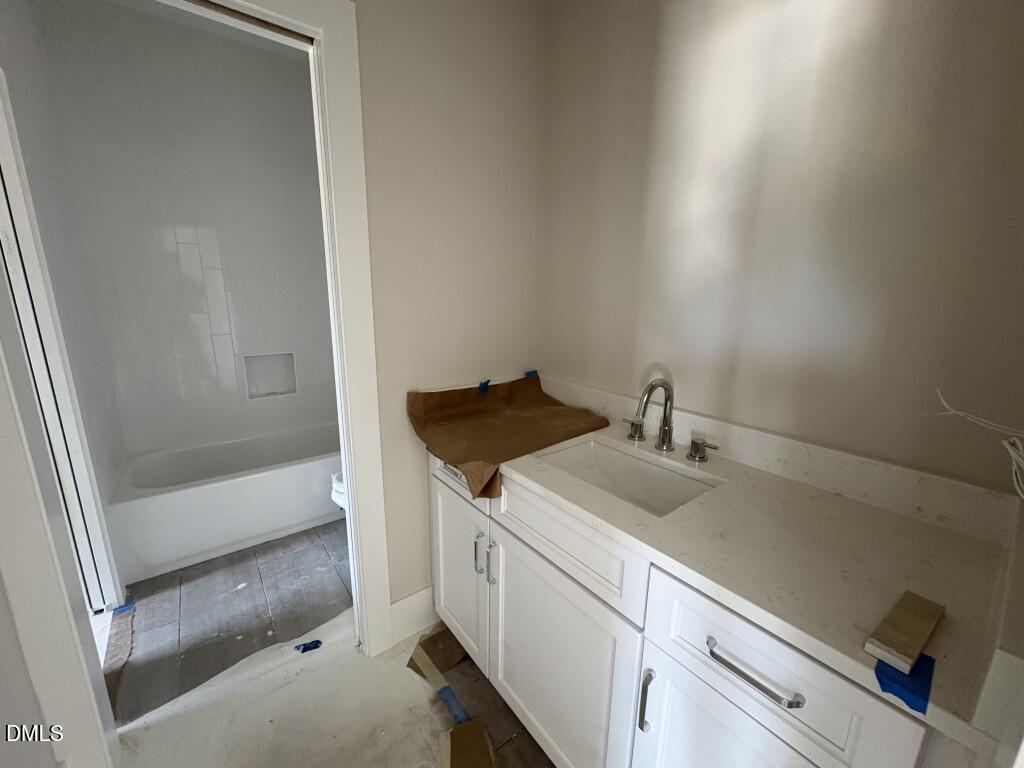 5864 Carriage Gate Drive Raleigh, NC 27603 - Photo 21 of 37 a bathroom with a sink and a shower