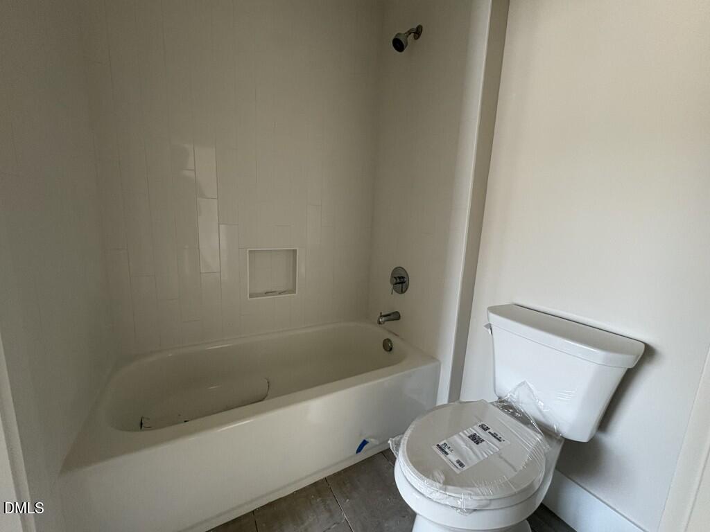 5864 Carriage Gate Drive Raleigh, NC 27603 - Photo 22 of 37 a bathroom with a tub and toilet