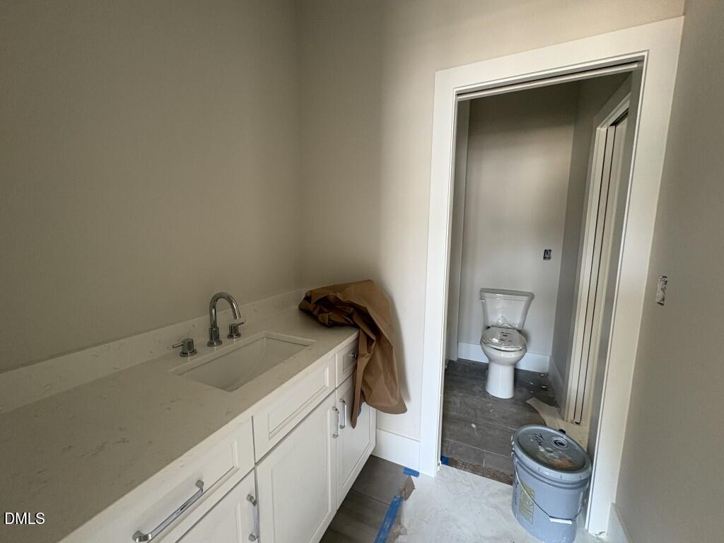 5864 Carriage Gate Drive Raleigh, NC 27603 - Photo 25 of 37 a bathroom with a sink and a toilet