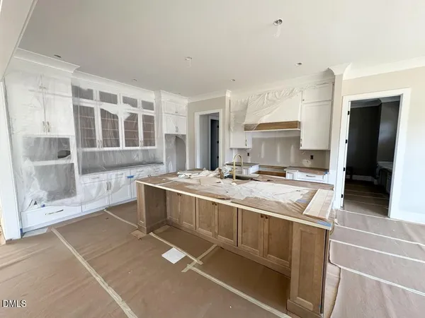 a large white kitchen with a large window