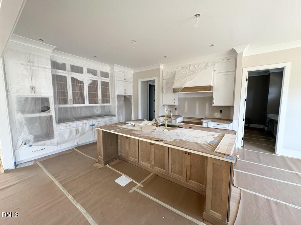 5864 Carriage Gate Drive Raleigh, NC 27603 - Photo 5 of 37 a large kitchen with kitchen island a sink stainless steel appliances and cabinets