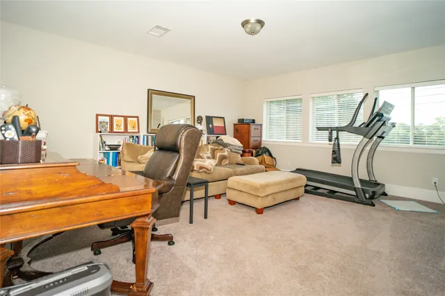 a bedroom with furniture and a flat screen tv