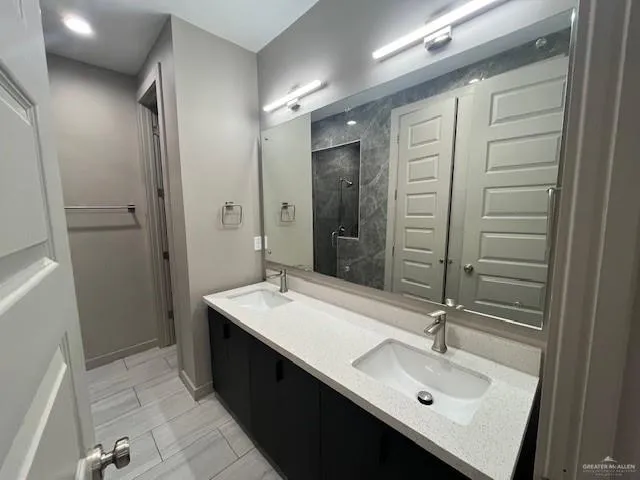 a bathroom with a sink double vanity and a mirror