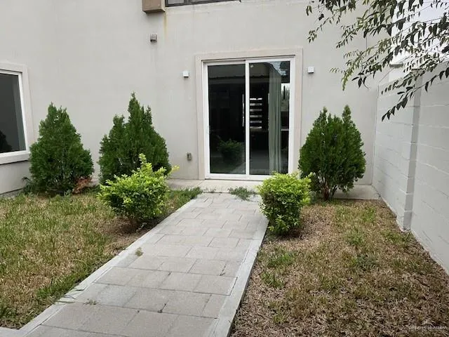 a view of a pathway with a garden