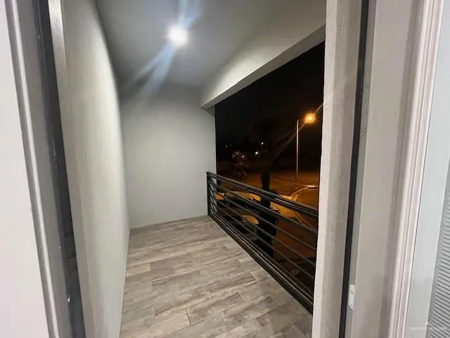 a room with wooden floor and furniture