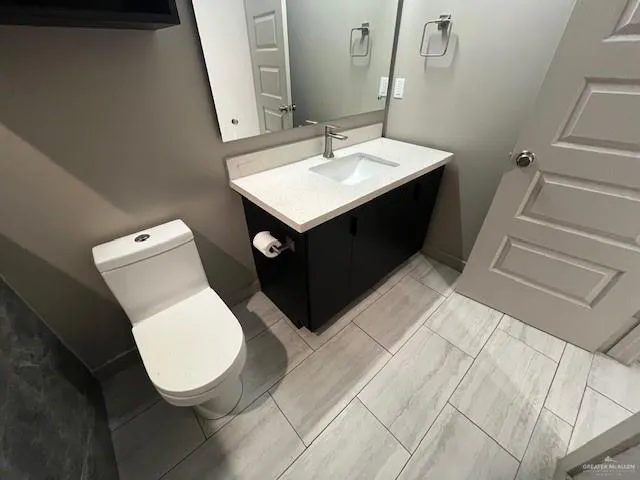 a bathroom with a sink toilet and mirror