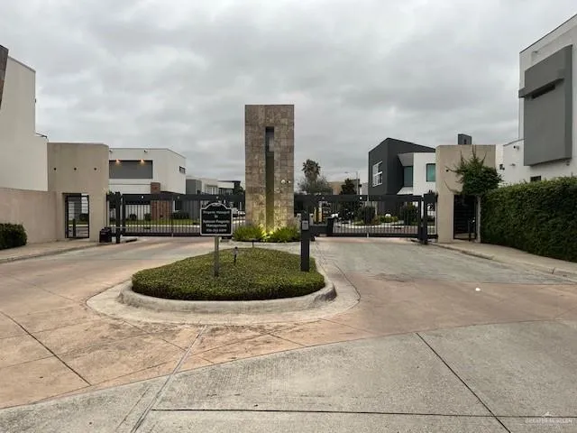 a swimming pool with outdoor seating and a garden