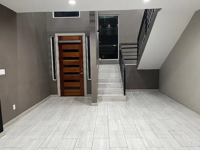 a view of an empty room with stairs