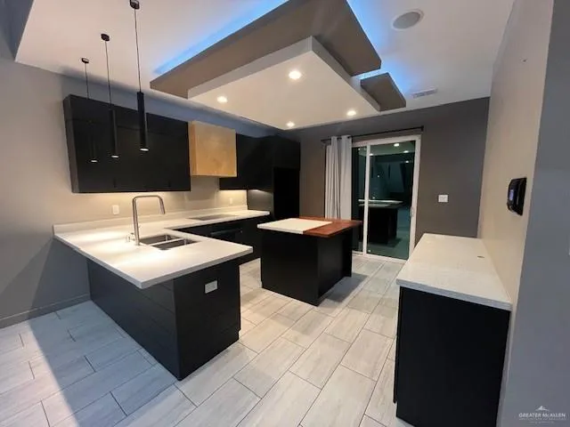 a kitchen with a sink refrigerator and cabinets