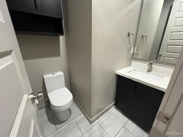 a bathroom with a toilet a sink and mirror