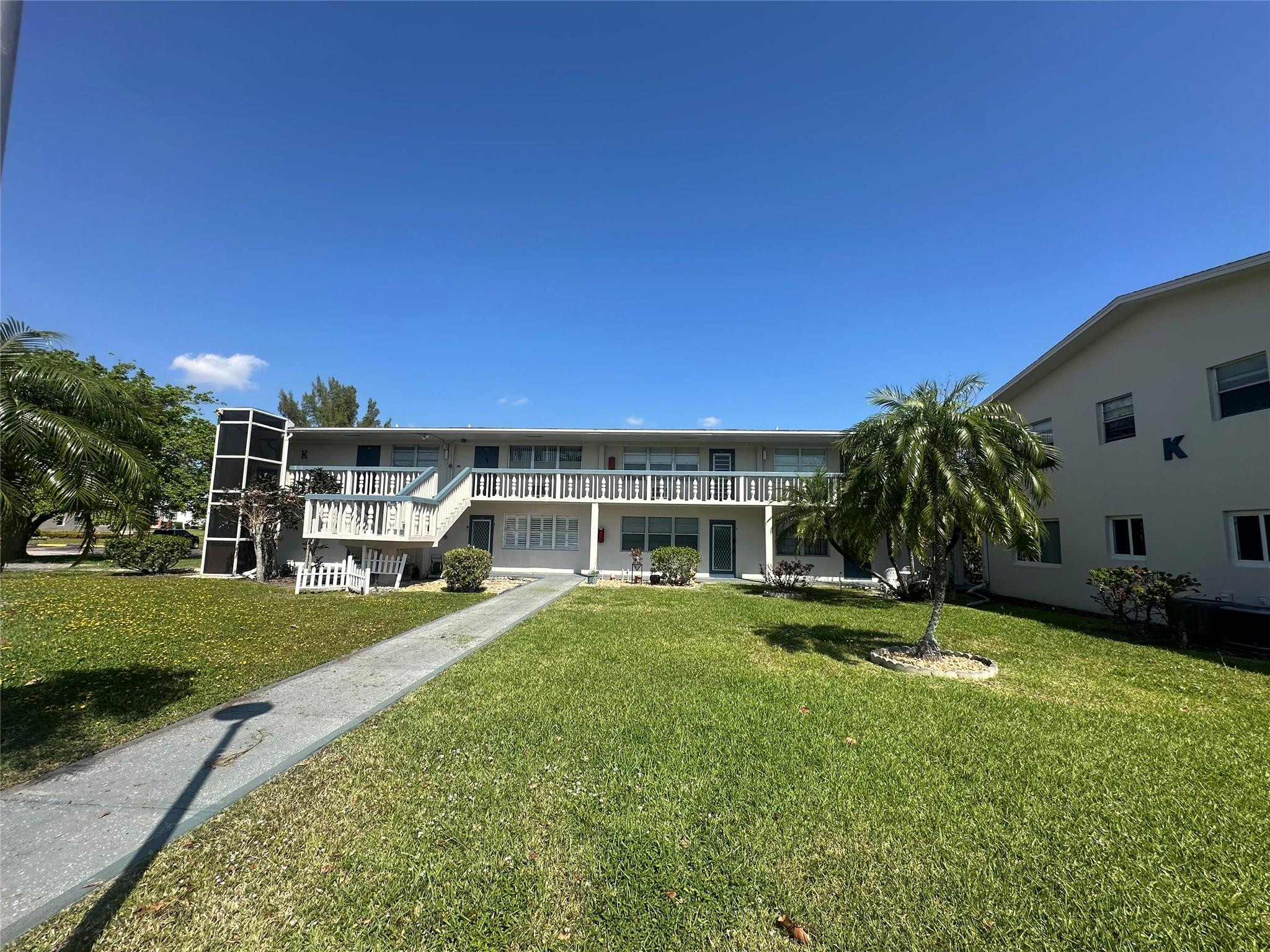 263 Farnham K, Unit 263 Deerfield Beach, FL 33442 - Photo 1 of 48 a view of house with outdoor space and swimming pool