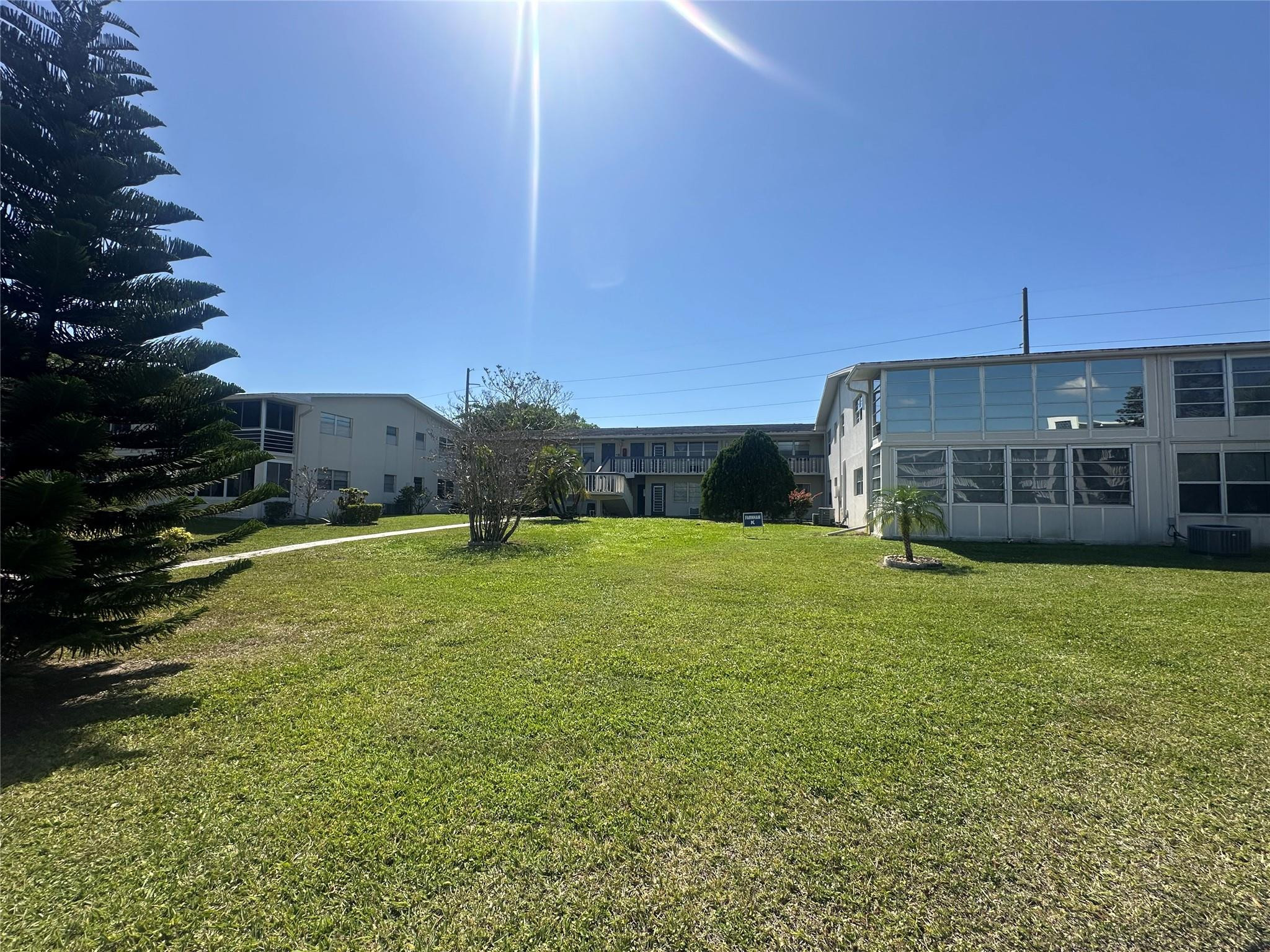 263 Farnham K, Unit 263 Deerfield Beach, FL 33442 - Photo 20 of 48 a view of a house with a backyard