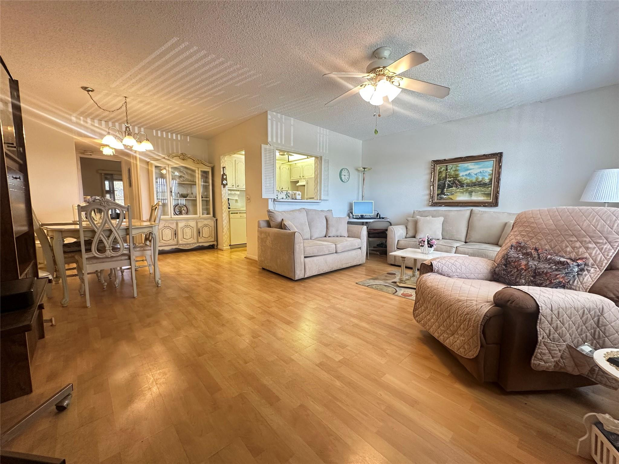 263 Farnham K, Unit 263 Deerfield Beach, FL 33442 - Photo 2 of 48 a living room with furniture and a chandelier