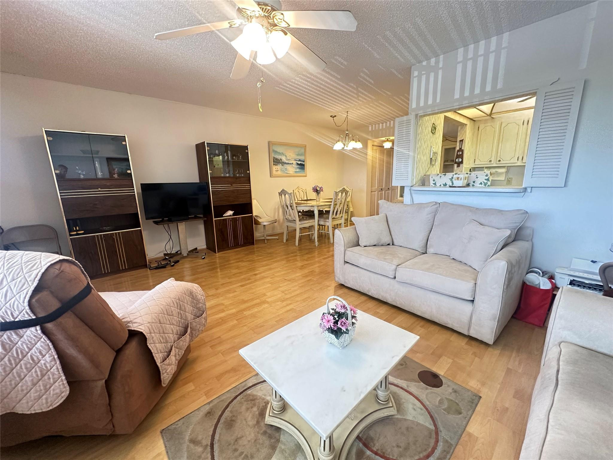 263 Farnham K, Unit 263 Deerfield Beach, FL 33442 - Photo 5 of 48 a living room with furniture and a flat screen tv