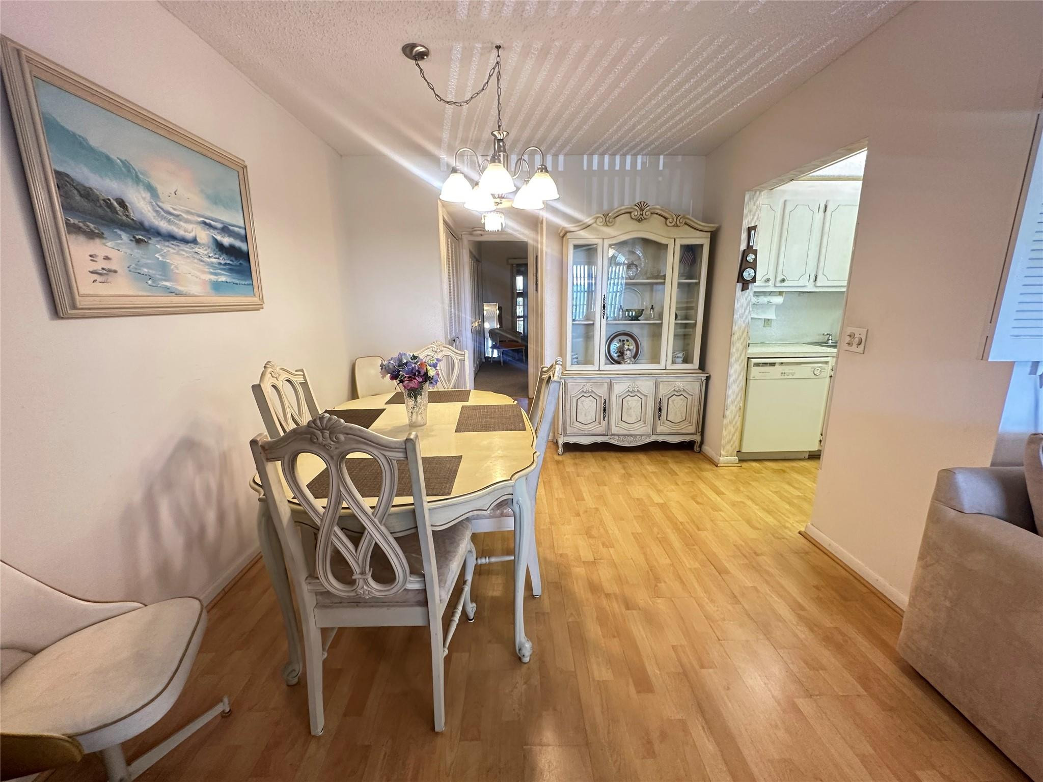 263 Farnham K, Unit 263 Deerfield Beach, FL 33442 - Photo 6 of 48 a dining room with furniture and wooden floor