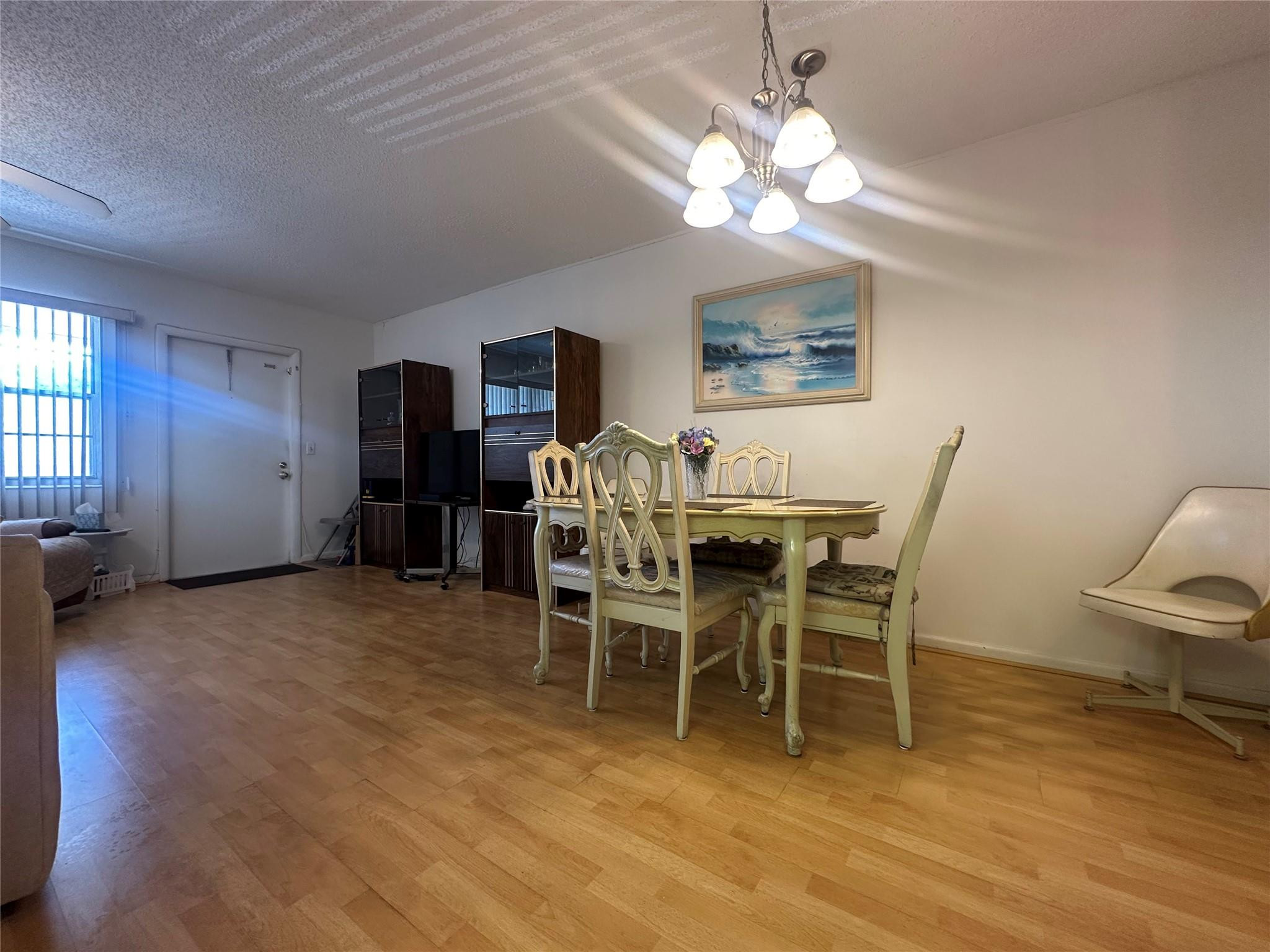 263 Farnham K, Unit 263 Deerfield Beach, FL 33442 - Photo 7 of 48 a view of a dining room with furniture and chandelier
