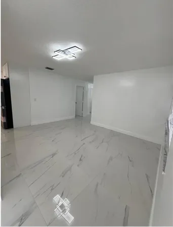 a kitchen with stainless steel appliances a refrigerator sink and cabinets