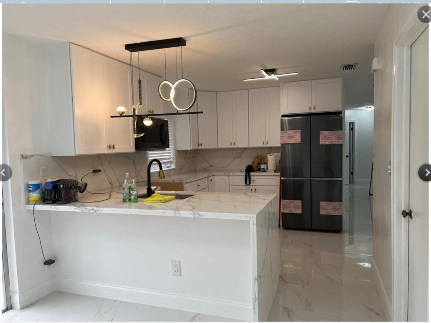 22062 Acapulco Court Boca Raton, FL 33428 - Photo 3 of 9 a kitchen with stainless steel appliances a refrigerator sink and cabinets