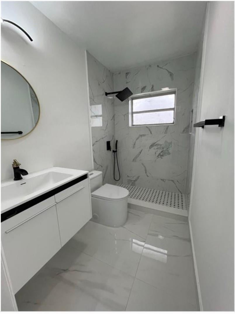 22062 Acapulco Court Boca Raton, FL 33428 - Photo 9 of 9 a bathroom with a double vanity sink toilet and a mirror