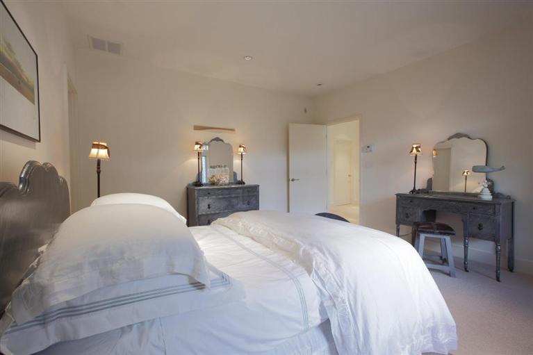 5 Mute Swan Circle Mashpee, MA 02649 - Photo 21 of 34 a bedroom with a bed and a table in it