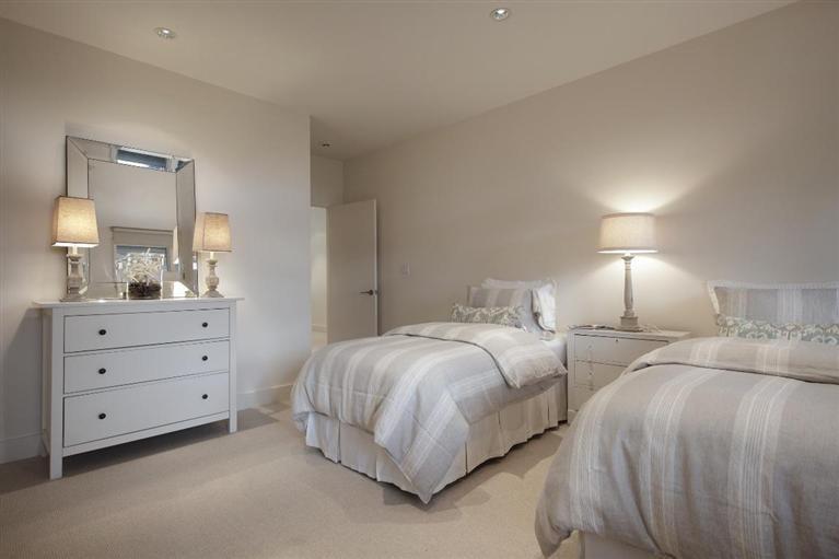 5 Mute Swan Circle Mashpee, MA 02649 - Photo 23 of 34 a spacious bedroom with two beds and a lamp