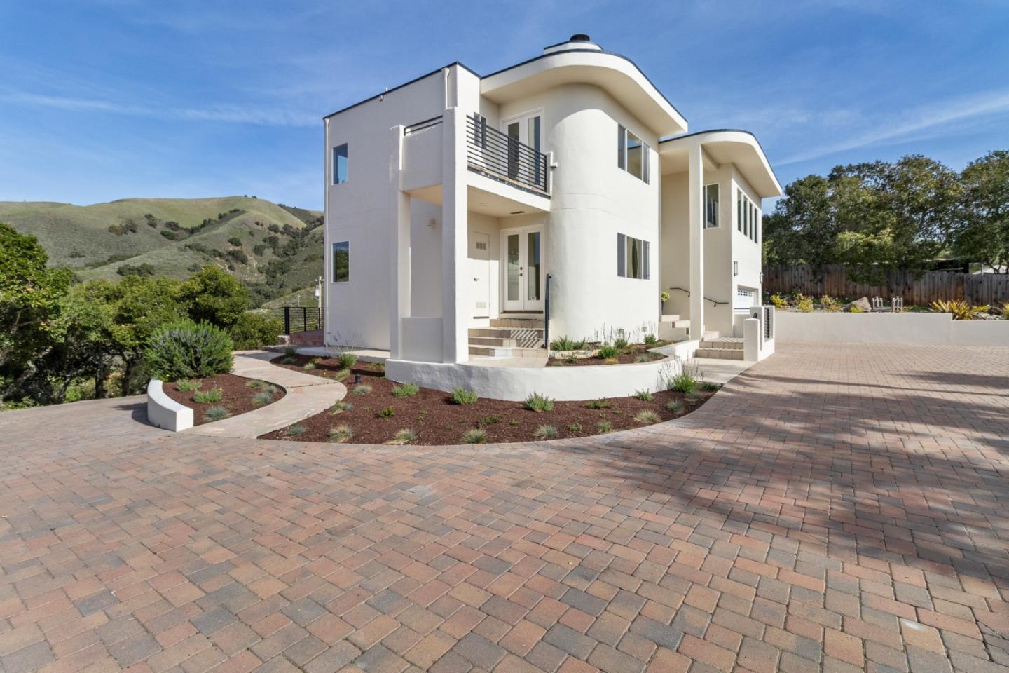 320 El Caminito Road Carmel Valley, CA 93924 - Photo 3 of 62 a view of a white house with a yard plants and large tree