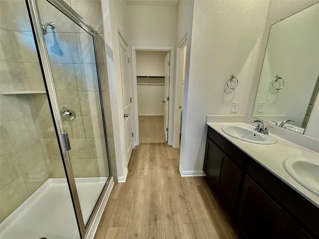 a bathroom with a sink a mirror and a shower