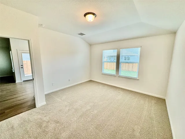 an empty room with windows and entrance