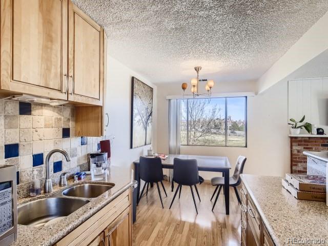 2141 Baseline Road, Unit 12 Boulder, CO 80302 - Photo 5 of 20 a kitchen with a table chairs sink and cabinets