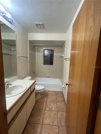 a bathroom with a double vanity sink toilet and shower
