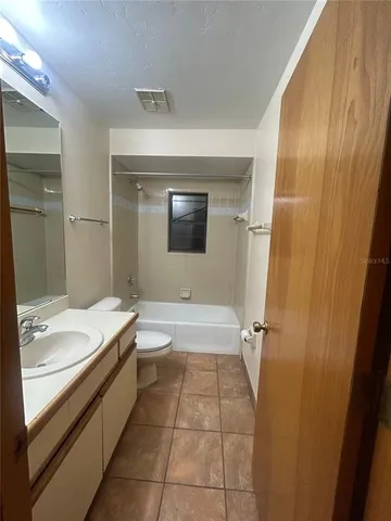 a bathroom with a double vanity sink toilet and shower