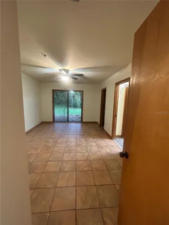a view of a livingroom with an empty space and a window