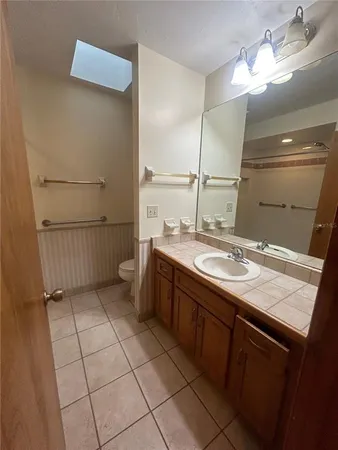 a bathroom with a sink a vanity and a mirror