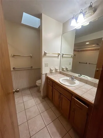 a bathroom with a sink a vanity and a mirror