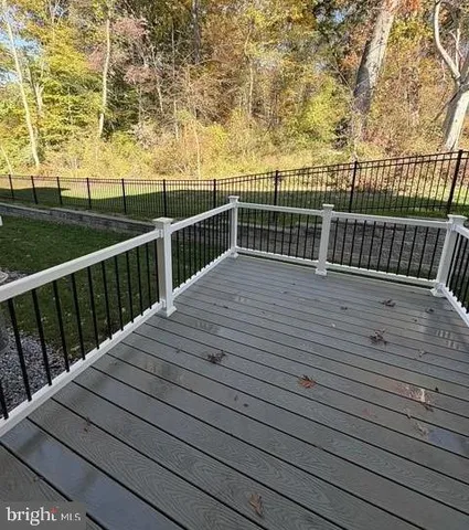 a view of deck with wooden floor and fence with a wooden floor