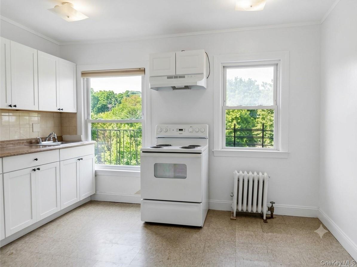 107 Kensington Road, Unit 5 Bronxville, NY 10708 - Photo 5 of 20 a kitchen with a stove a sink and a window