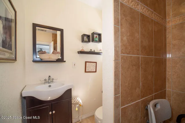 a bathroom with a sink a toilet and shower curtain