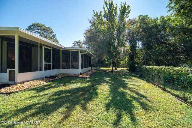 a backyard of a house with yard and outdoor seating