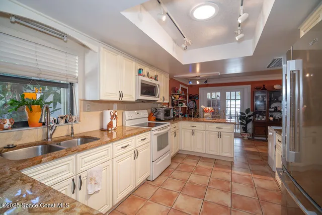 a kitchen with a sink cabinets and window