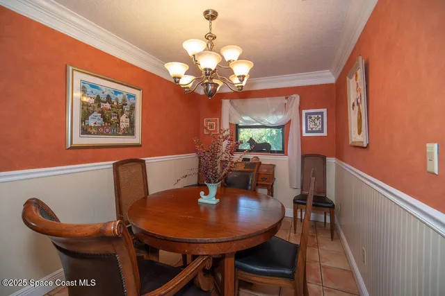 a dining room with furniture and chandelier