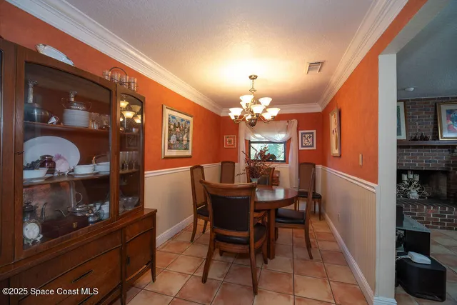a dining room with furniture and chandelier