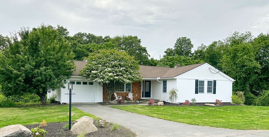 123 Burbank Road Sutton, MA 01590 - Photo 1 of 20 a front view of a house with a yard and garage