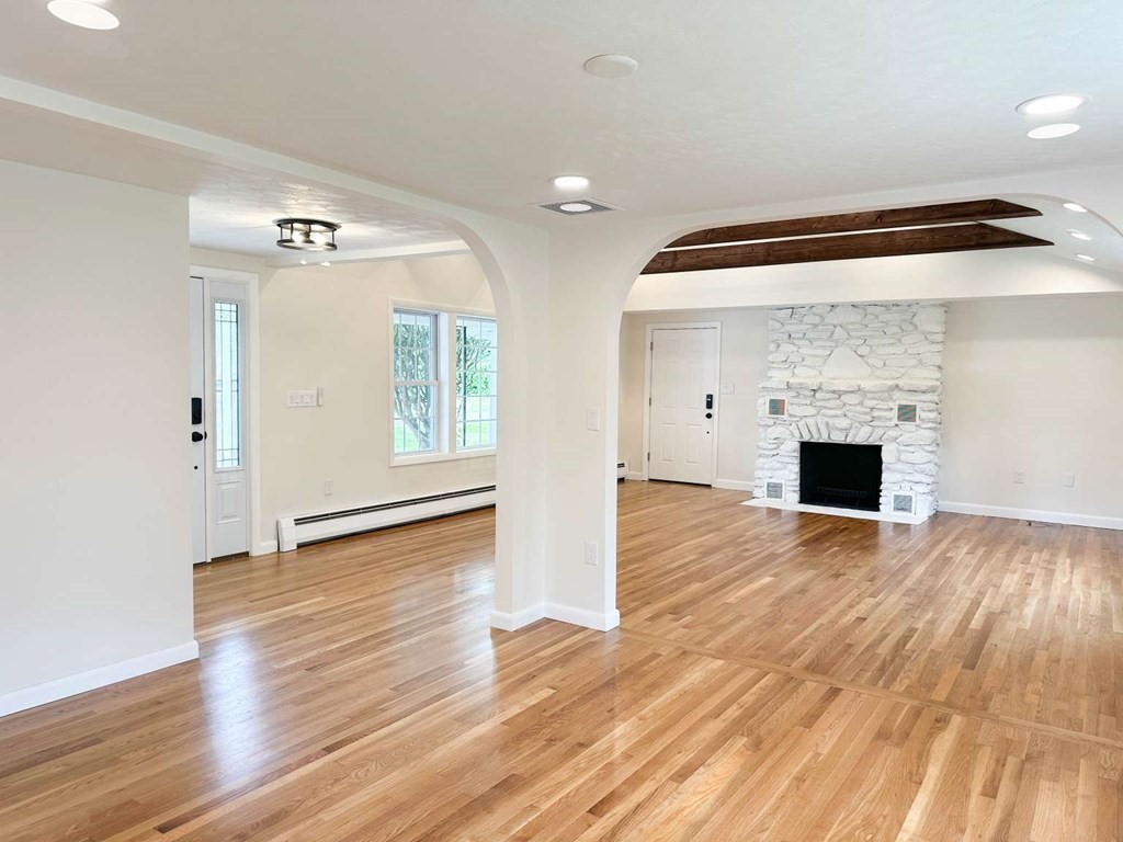 123 Burbank Road Sutton, MA 01590 - Photo 11 of 20 a view of empty room with wooden floor and fireplace