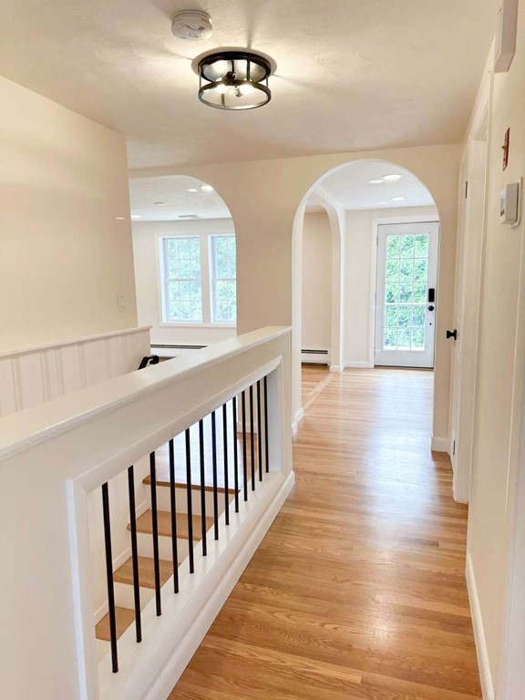 123 Burbank Road Sutton, MA 01590 - Photo 13 of 20 a view of a hallway with wooden floor and staircase