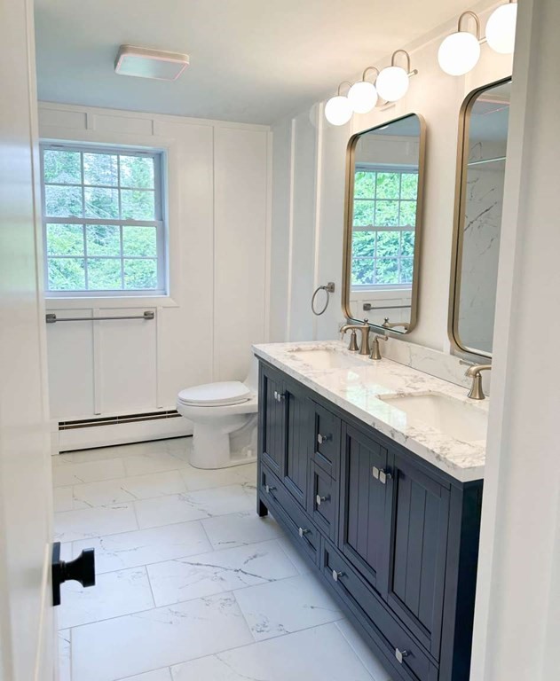 123 Burbank Road Sutton, MA 01590 - Photo 15 of 20 a bathroom with a double vanity sink toilet and a mirror